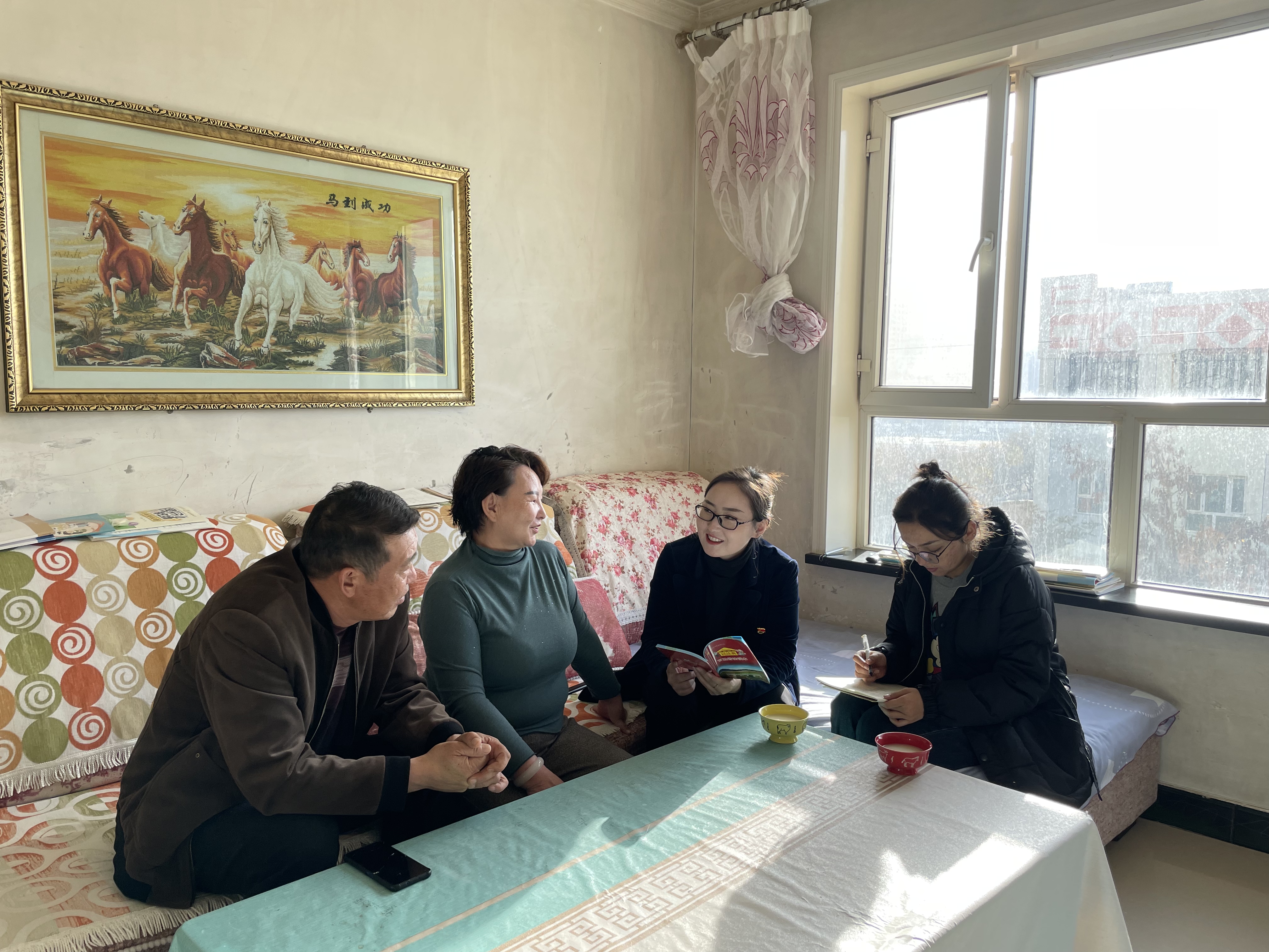 珠乐（右二）与同事在牧民群众家中交谈了解情况.jpg